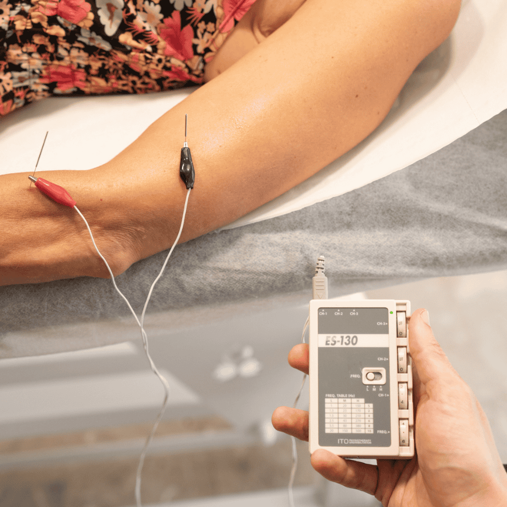 Un chico realizando una sesión de neuromodulación ecoguiada en un centro de fisioterapia en Santa Eugènia de Berga